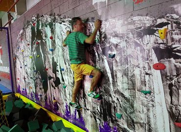 Trampoline park climbing wall attraction